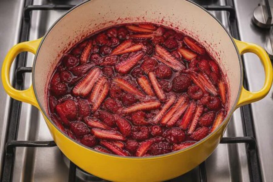 Morangos e framboesas a cozer numa panela